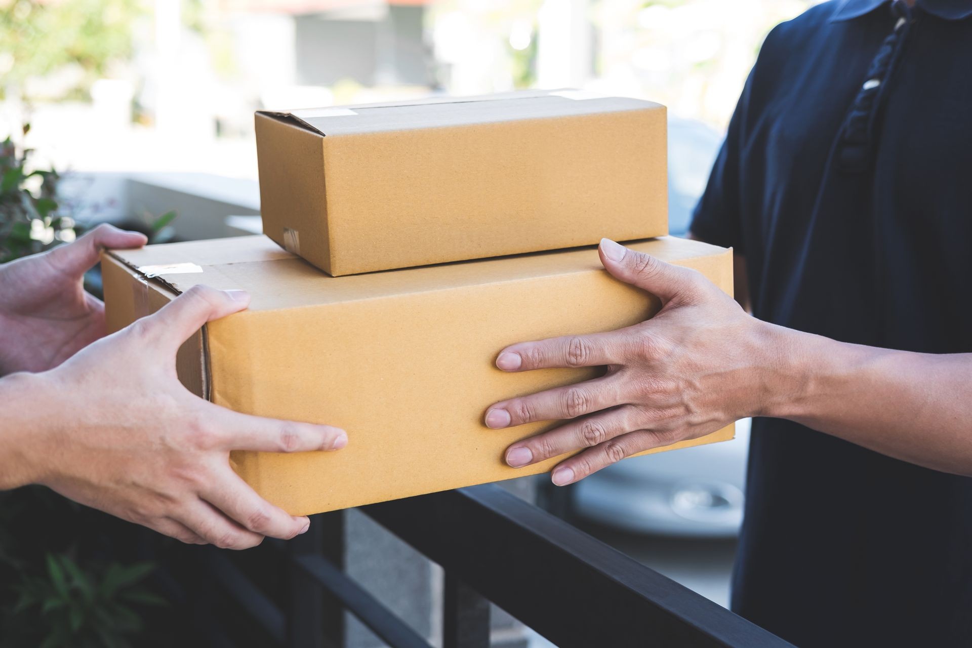 Delivery mail man giving parcel box to recipient, Young owner accepting of cardboard boxes package from post shipment, Home courier and delivery service mind concept.